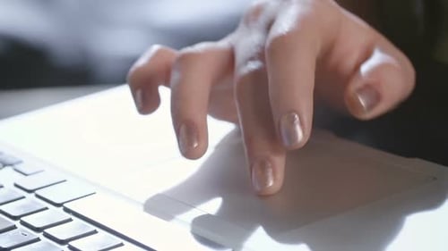 Hand Operating Laptop Trackpad in Close Up