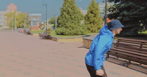 Jumping Parkour in a City Park. Guys Do Backflips in the Park, on the Street