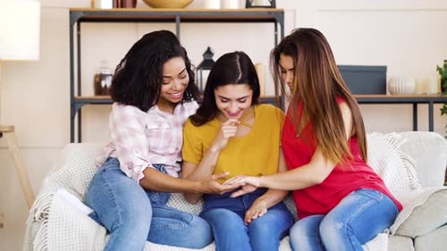 Woman Showing Diamond Ring To Friends at Home