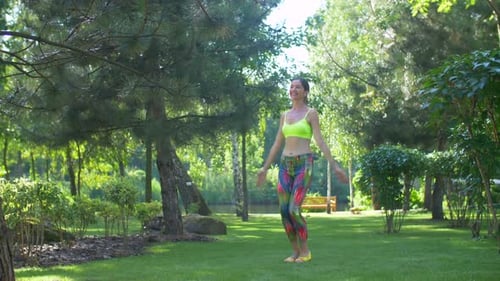 Active Woman Doing Fitness Exercise on Green Grass