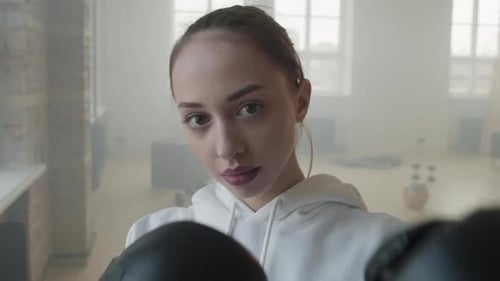 Close-Up Portrait Of Woman In Boxing Gloves