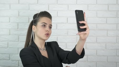 Glamorous Woman Recording Herself with Phone Indoors