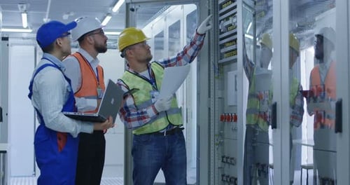 Electrical Workers Working in the Control Room