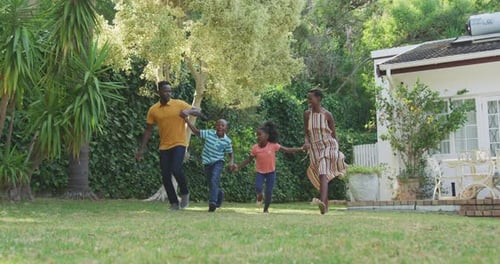 Joyful Family Running Together in the Backyard