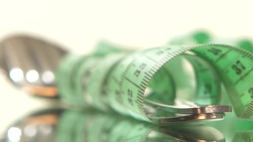 Banana Wrapped Up with Measure Tape, Reflection, Rotation, on White, Close Up