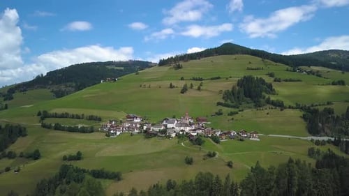 Fly Over a Small Mountain Village in the Dolomites in Italy