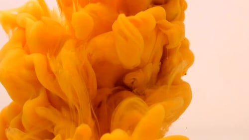Vibrant Orange Ink Dispersing in Liquid Medium