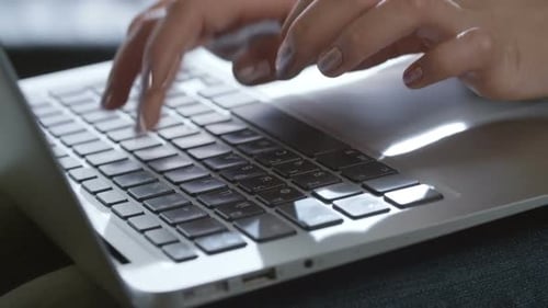 Female Hands Typing on Laptop