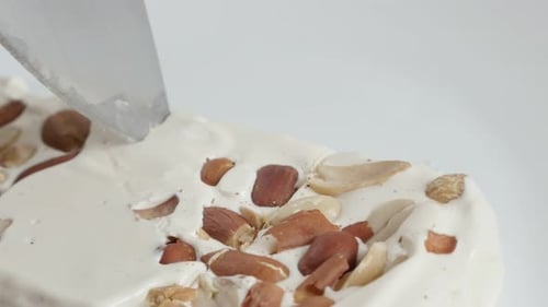 Cutting of honey nougat halva with knife 4K footage