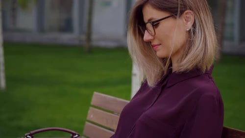 Freelancer manager typing working on laptop remotely outdoor park sitting on a bench.