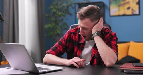 A Tired and Bored Teenage Student Boy Yawns and Falls Asleep Sitting in a Chair