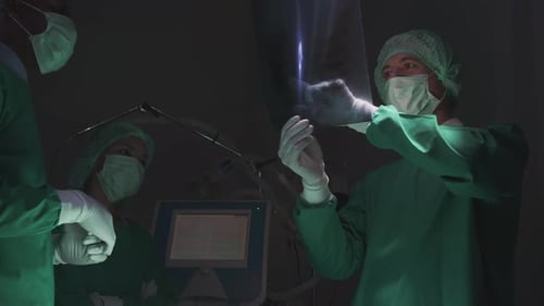 Surgeons Studying X-Ray in Hospital Operating Room