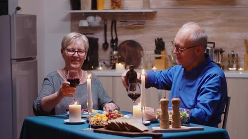 Mature Couple Having an Anniversary Dinner with Wine