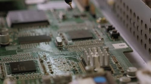 Technician Repairing Circuit Board Electronic Components