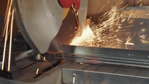 Work in Production with Metal. A Disk That Rotates and Cuts Metal Close Up. Sparks Flying From the