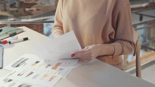 Close Up of Female Fashion Designer Working with Illustrations