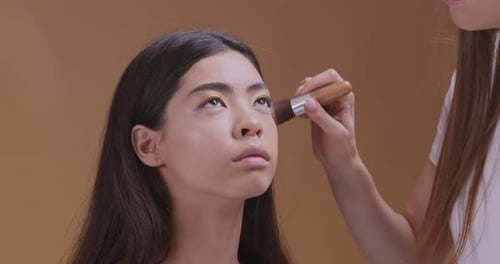 Make-up Artist Applying Blush to Model's Face