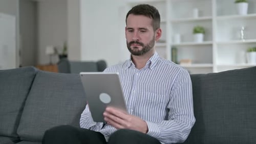Professional Young Man Using Tablet in Office