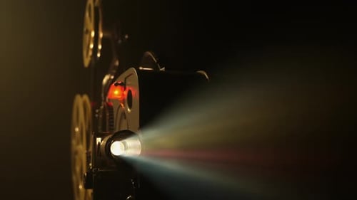 Vintage Movie Projector Shining Light in the Dark