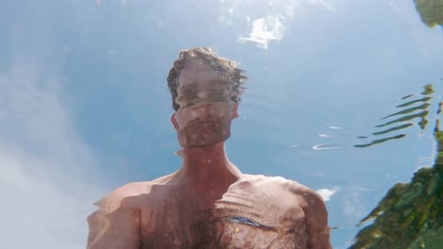 Man Swimming Underwater in Tropical Ocean