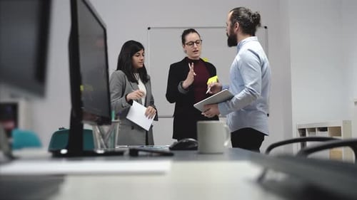 Team Collaborating on Tablet in Office Setting