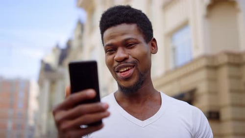 Excited Afro Guy Having Video Call Street