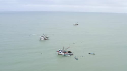 Aerial view, circling around a smal fishing boat