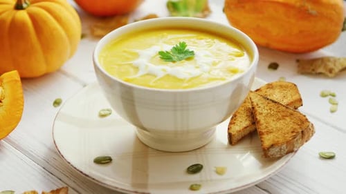 Pumpkin Soup in Bowl Served with Bread
