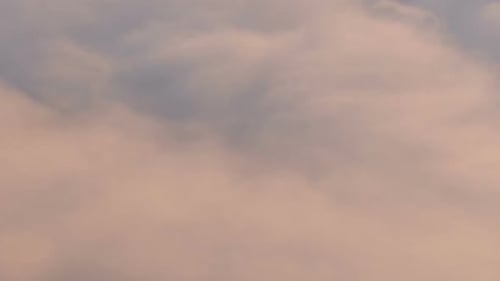 Pink Clouds Moving Over Misty Mountain Tops