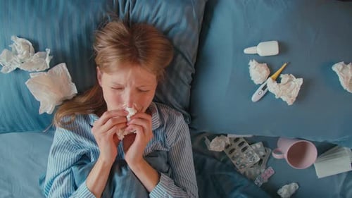 Sick Woman Coughing Lying in Bed Taking Pills