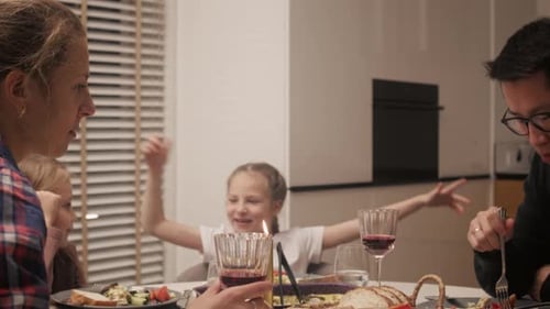 Family Eating Dinner Together at Home Around Table