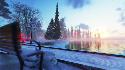 Peaceful Winter Park Lake with Falling Snow and Golden Sunset