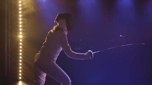 Two Female Athletes Practice Their Foil Skills at a Fencing Tournament
