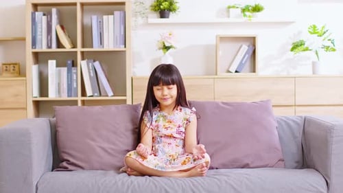 Girl Meditating on Couch in Living Room