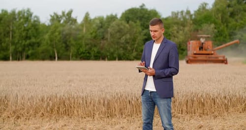 Farmer Using Tablet in Wheat Field