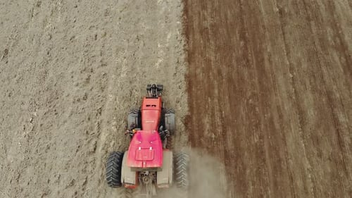 Tractor Tilling Soil in a Rural Field