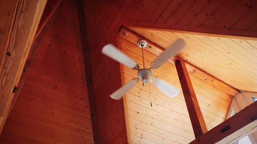 Ceiling Fan Spinning Under Wooden A-Frame Ceiling