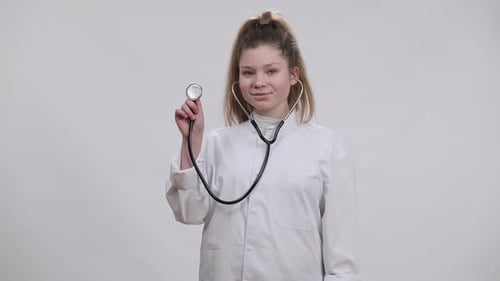 Young Woman Doctor Holding Stethoscope in Hospital Setting