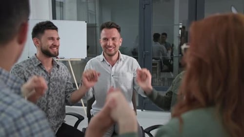 Motivated Team Holding Hands and Clapping