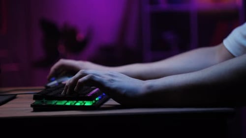 Spieler tippen auf Hintergrundbeleuchtung Tastatur Nahaufnahme Mann spielt Videospiel