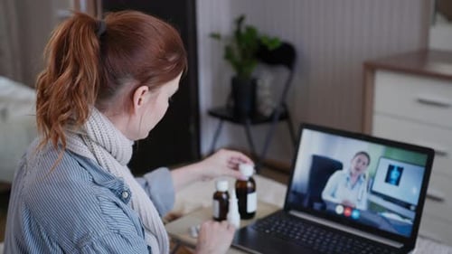 Woman having video call with doctor from home