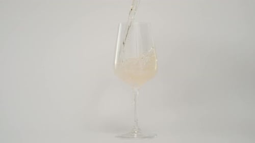 Slow Motion of Pouring Wine in Tilted Glass at 1000 Fps White Background