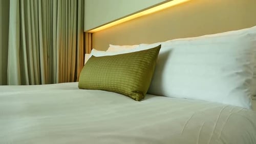 Comfortable Bed with Pillows in Hotel Room