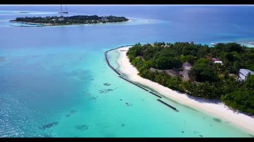Aerial drone shot landscape of idyllic coastline beach voyage by blue ocean with white sand backgrou