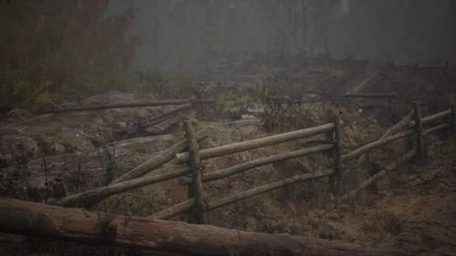 An Old Wood Fence with a Country Field Behind It