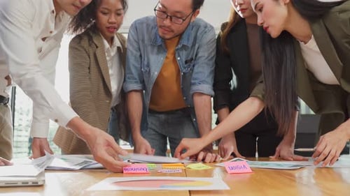 Close up hands of Asian young business people group meeting and brainstorming in office as team.