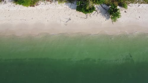 Beautiful sea waves and white sand beach in the tropical island.