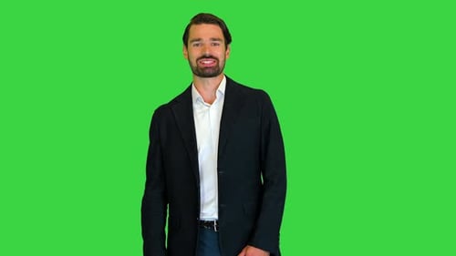 Excited Guy Greeting Waving a Hand and Talking To Camera on a Green Screen Chroma Key