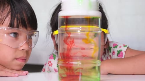 Children Observing a Colorful Science Experiment