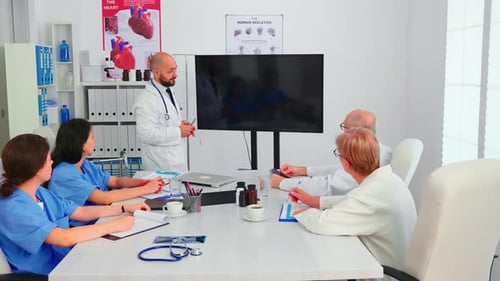 Doctor Making Presentation to Medical Staff in Hospital Radiology Area